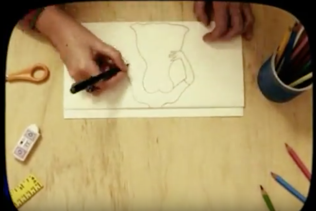 Artist drawing a woman's bpdy.