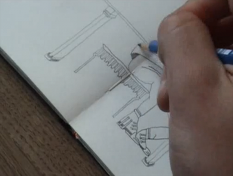 Artist drawing on a sketchbook.