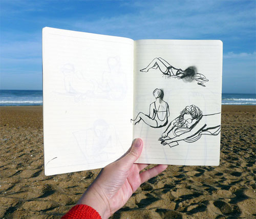 Person holding up sketchbook with the beach in the background, the sketchbook shows 3 sketches of women in various poses
