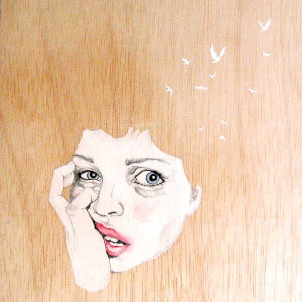 Painting of a face on a wood.