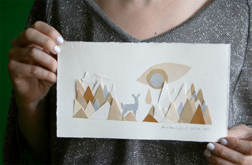 Paper art of a deer and mountains.