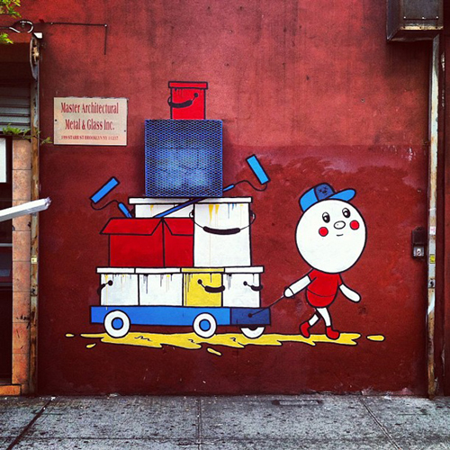 Painting on a wall of a white character pulling a wagon full of boxes