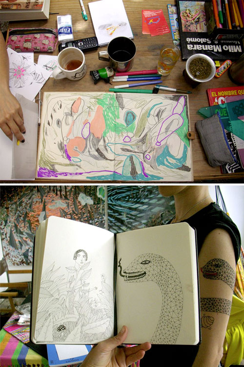 Image of a sketchbook on a desk surrounded by drawing tools