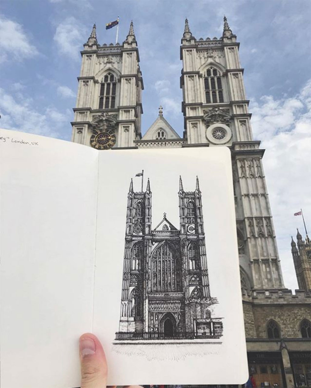 Drawing of Westminister Abbey with sketch held up to compare to the actual building